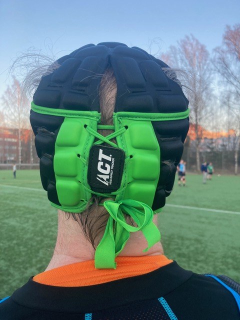 Sensor attached to green padded headgear