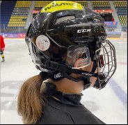 Ice hockey player wearing the sensor with a caged helmet
