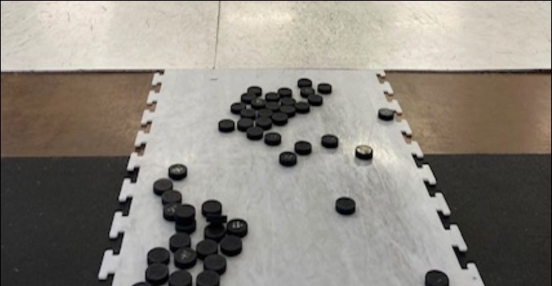 Pucks laid out on the impact test surface